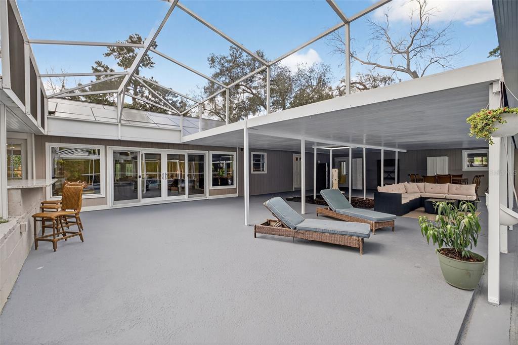 182 Parsons Road Longwood, FL 32779 - Photo 50 of 54 a view of a patio with a table and chairs and potted plants