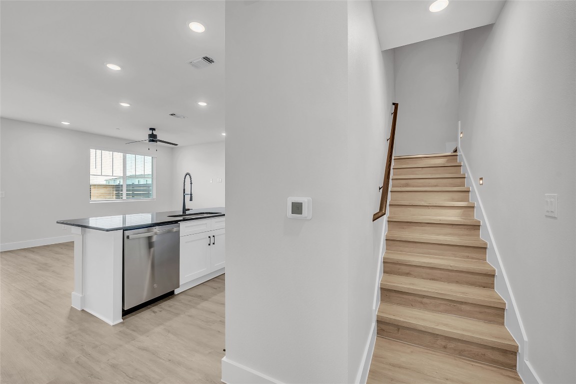 9317 Curious Squirrel Street Austin, TX 78744 - Photo 8 of 26 a kitchen with white cabinets and white appliances