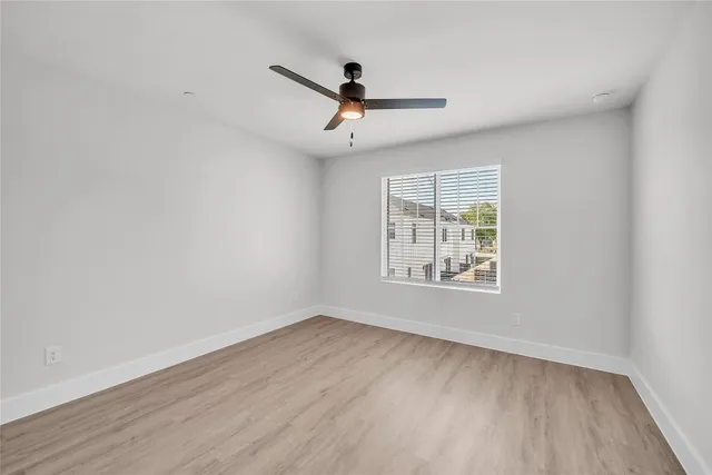 a large kitchen with a sink and refrigerator