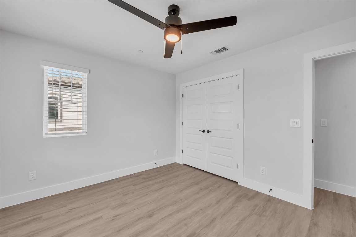 9317 Curious Squirrel Street Austin, TX 78744 - Photo 17 of 26 a view of room with hardwood floor and a ceiling fan