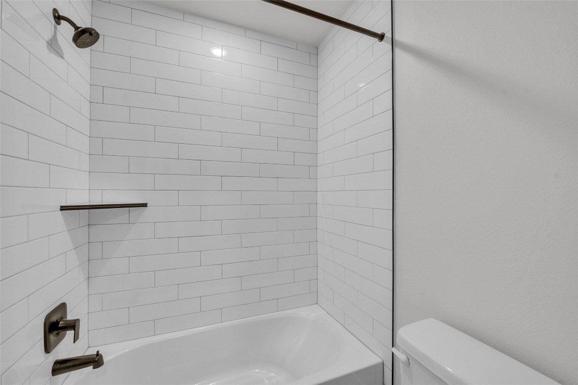 9317 Curious Squirrel Street Austin, TX 78744 - Photo 19 of 26 a bathroom with a shower and a bathtub