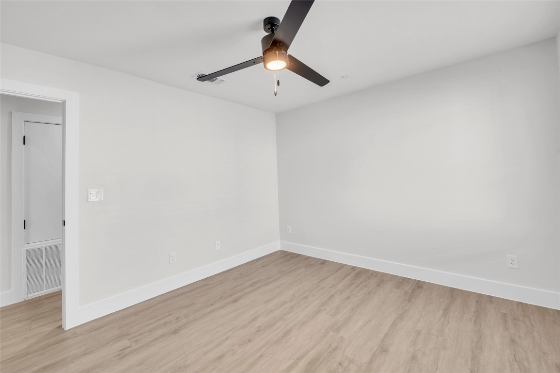 9317 Curious Squirrel Street Austin, TX 78744 - Photo 21 of 26 wooden floor in an empty room