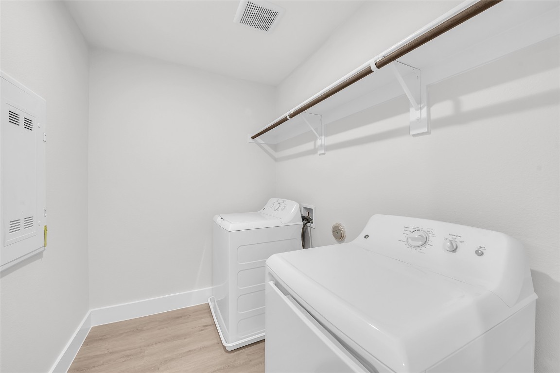 9317 Curious Squirrel Street Austin, TX 78744 - Photo 23 of 26 a utility room with dryer and washer