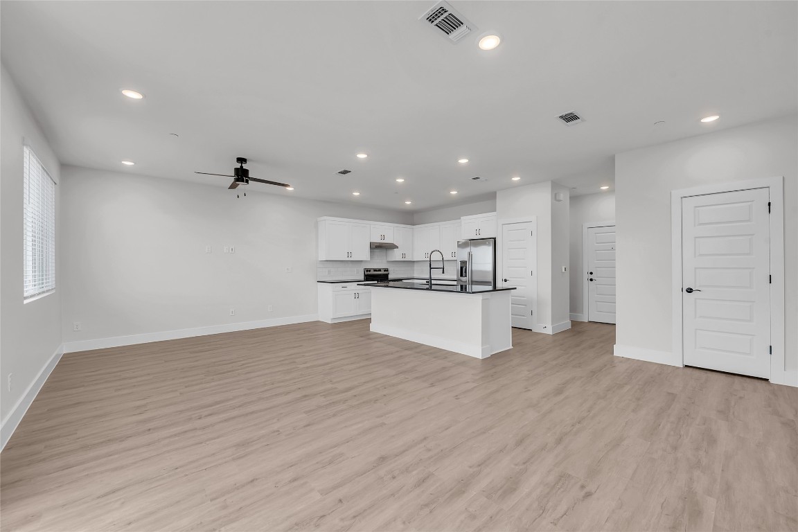 9317 Curious Squirrel Street Austin, TX 78744 - Photo 25 of 26 a view of kitchen with wooden floor