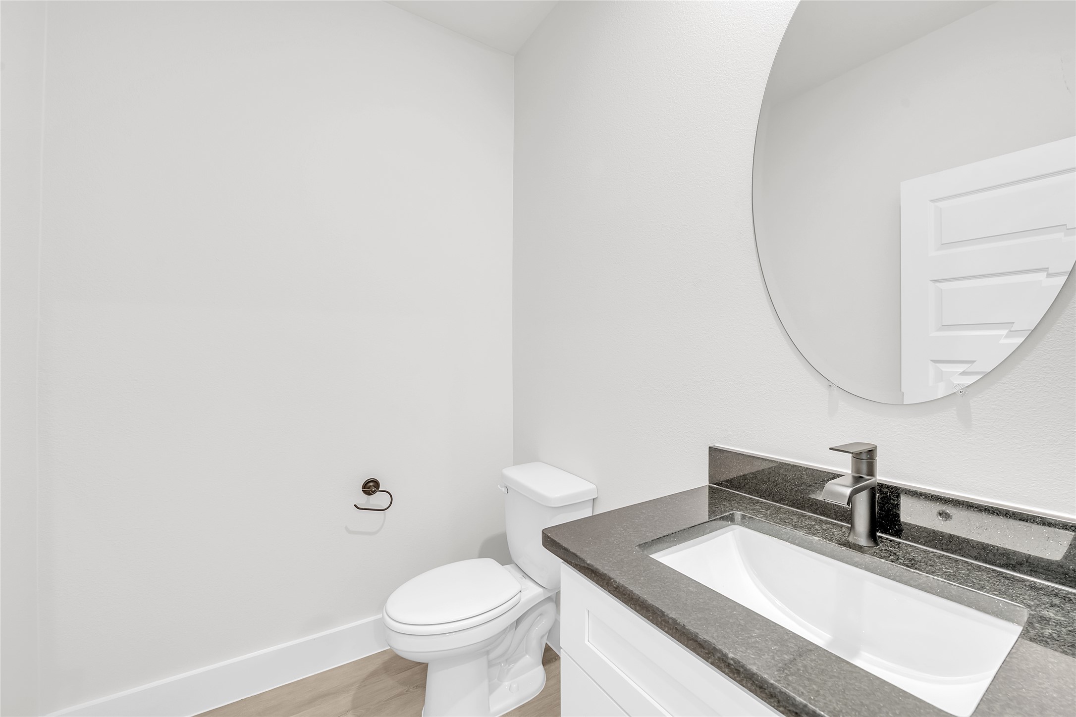 9317 Curious Squirrel Street Austin, TX 78744 - Photo 6 of 26 Half bath with vanity and toilet