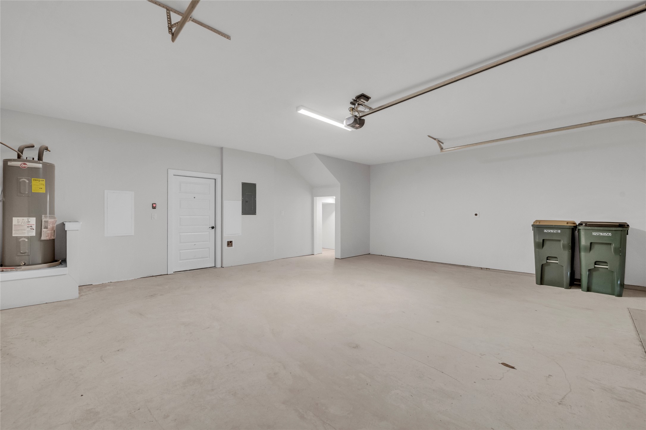 9317 Curious Squirrel Street Austin, TX 78744 - Photo 7 of 26 Garage with electric water heater and electric panel