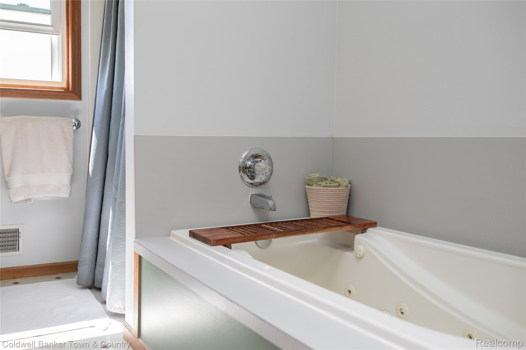 717 North Youngs Road Attica, MI 48412 - Photo 35 of 87 Soaking tub with integrated jets, chrome fixtures, and a natural wood window frame