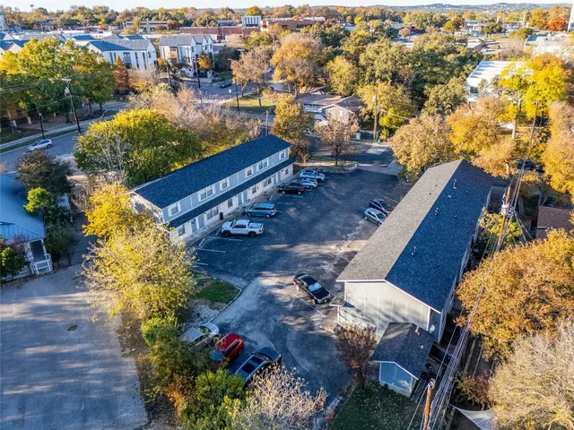 an aerial view of a house with a yard and lake view