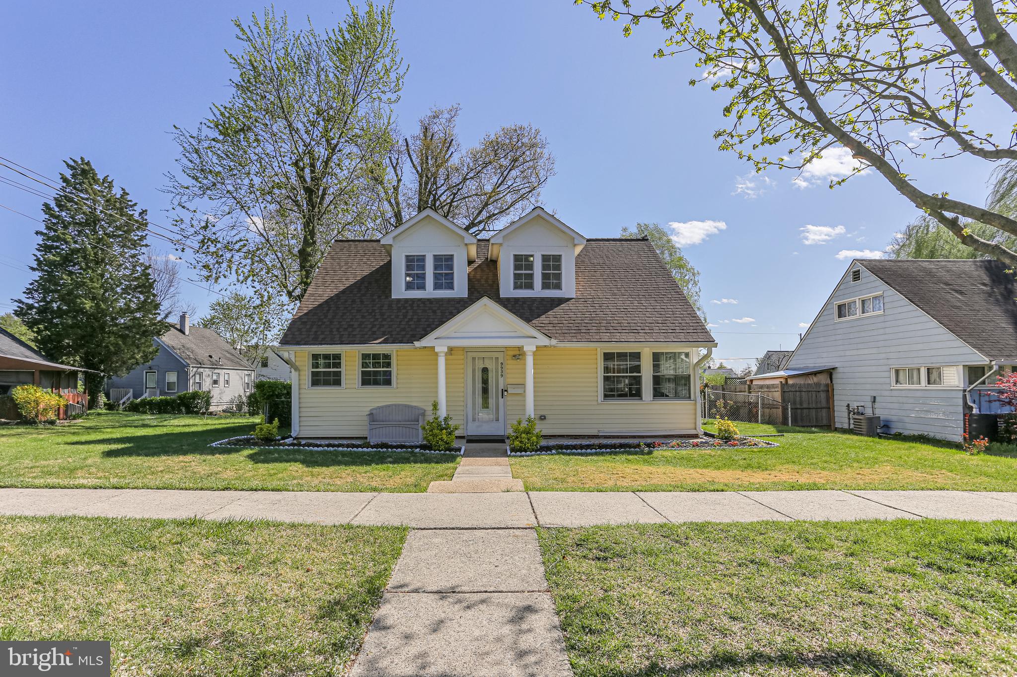 9939 Cottrell Terrace Silver Spring, MD 20903 - Photo 1 of 33 a front view of a house with a yard