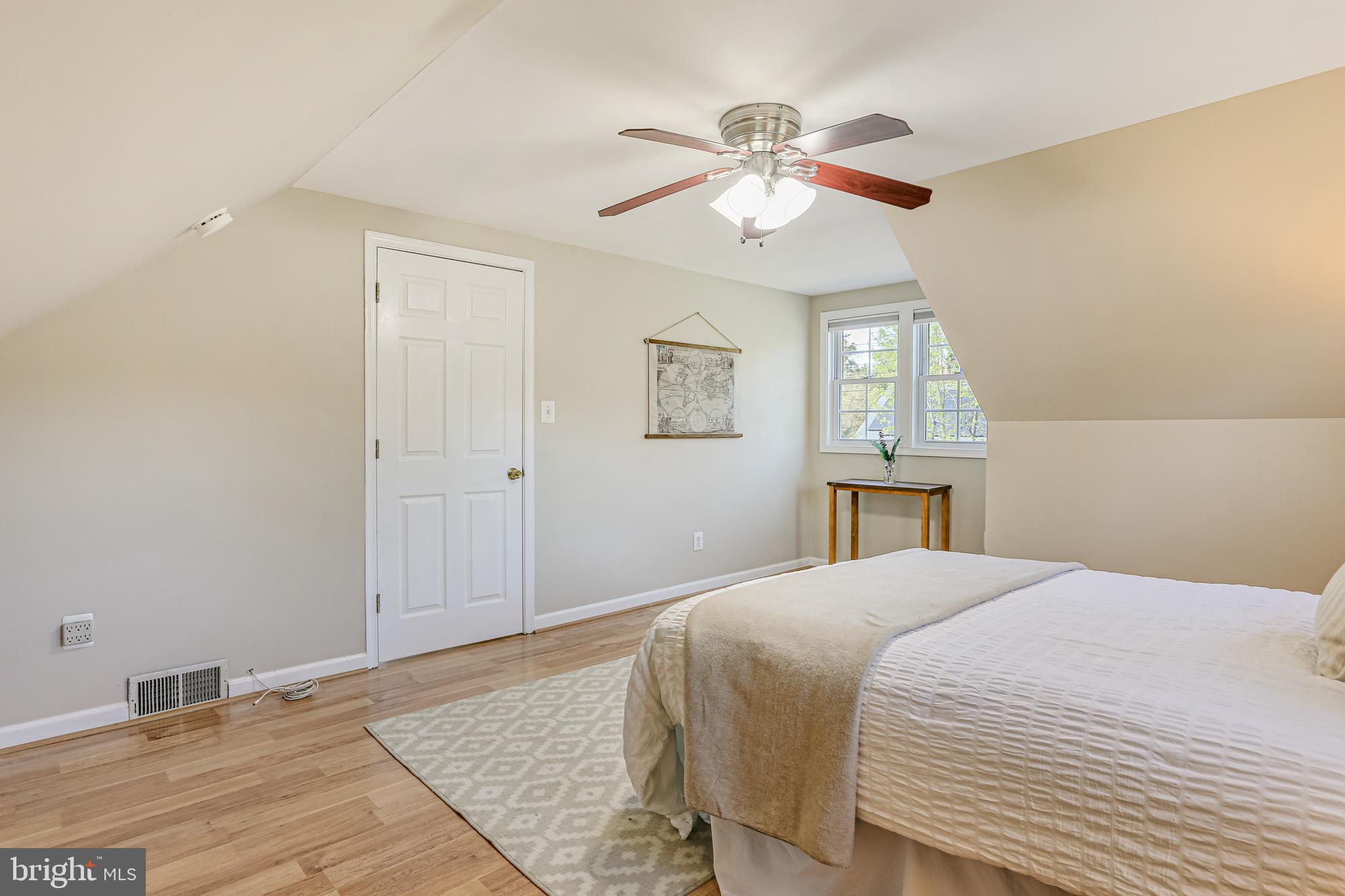 9939 Cottrell Terrace Silver Spring, MD 20903 - Photo 13 of 33 a bedroom with a large bed and a chandelier