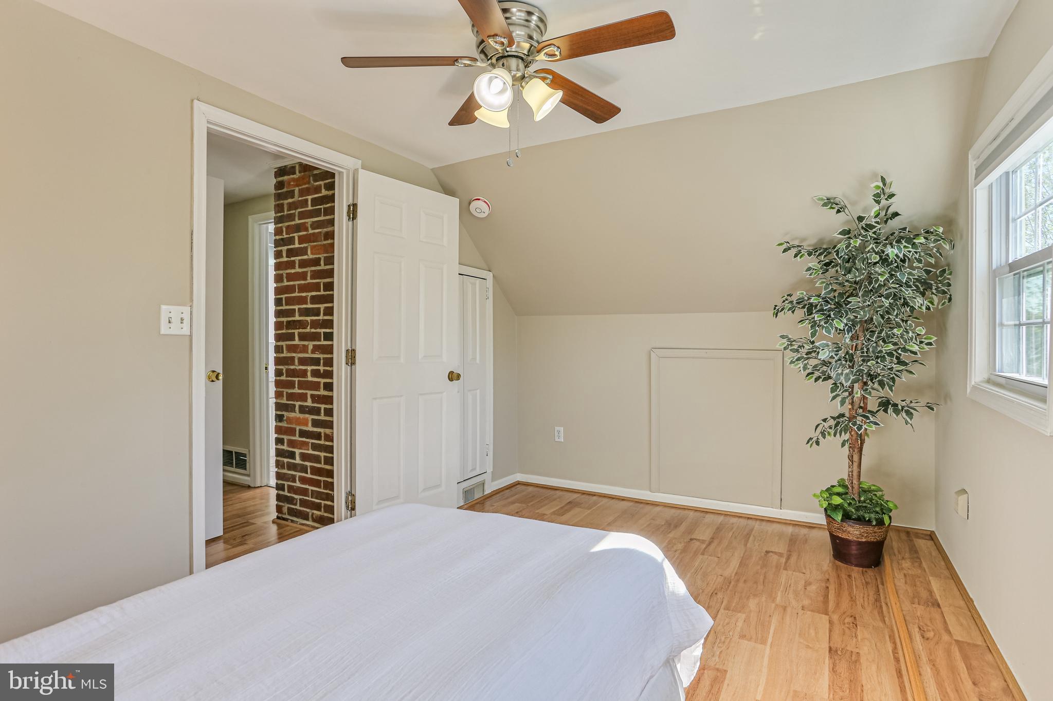 9939 Cottrell Terrace Silver Spring, MD 20903 - Photo 16 of 33 a bedroom with a bed and a potted plant