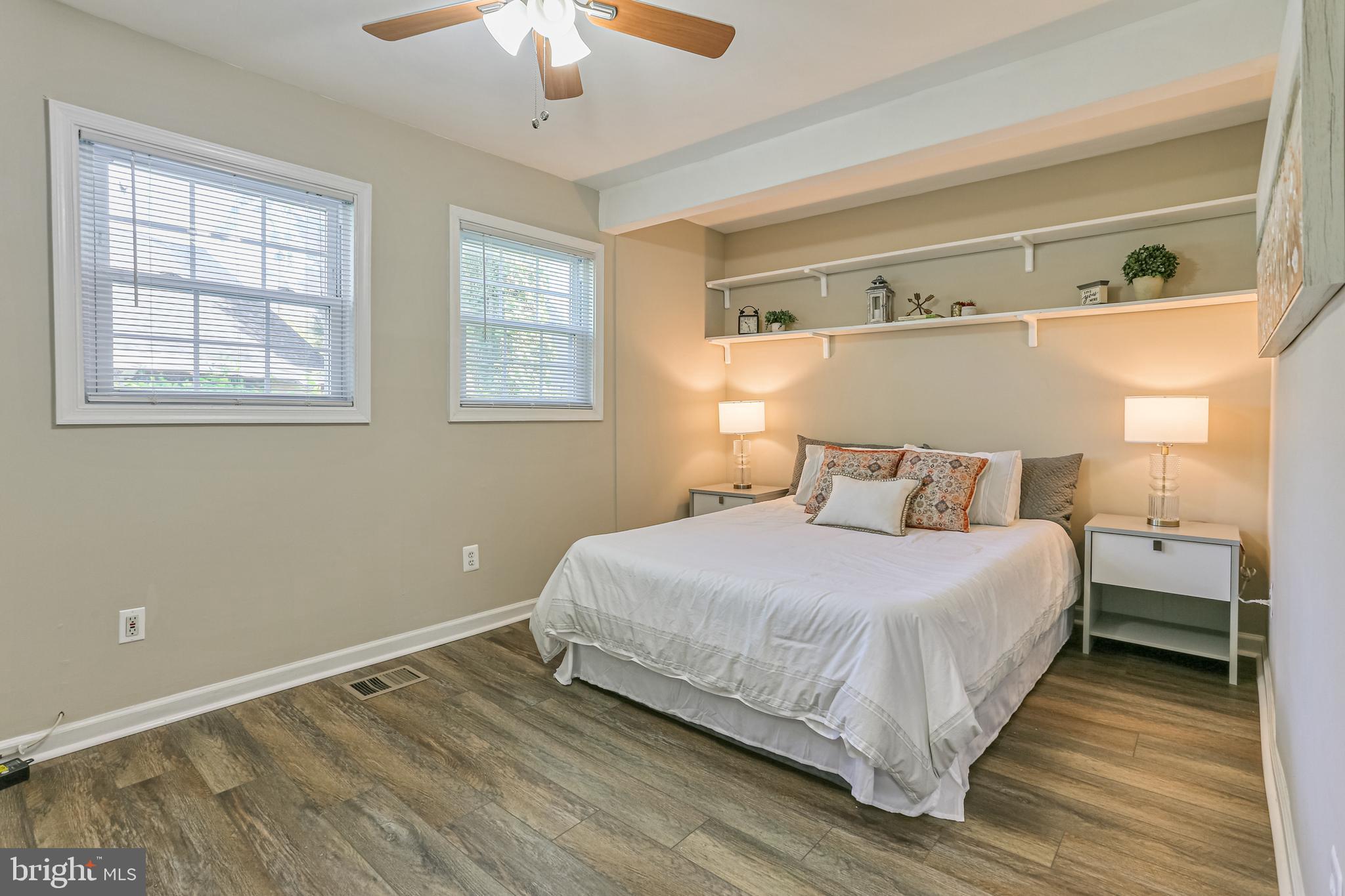 9939 Cottrell Terrace Silver Spring, MD 20903 - Photo 18 of 33 a bedroom with a bed and a window