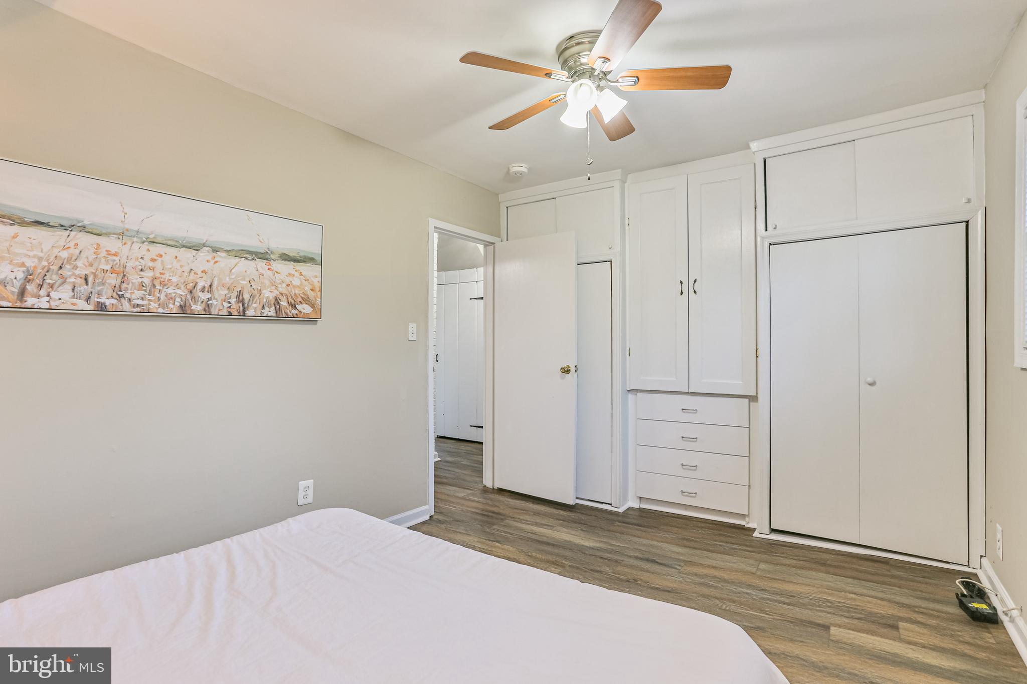 9939 Cottrell Terrace Silver Spring, MD 20903 - Photo 19 of 33 a bedroom with a bed and a chandelier