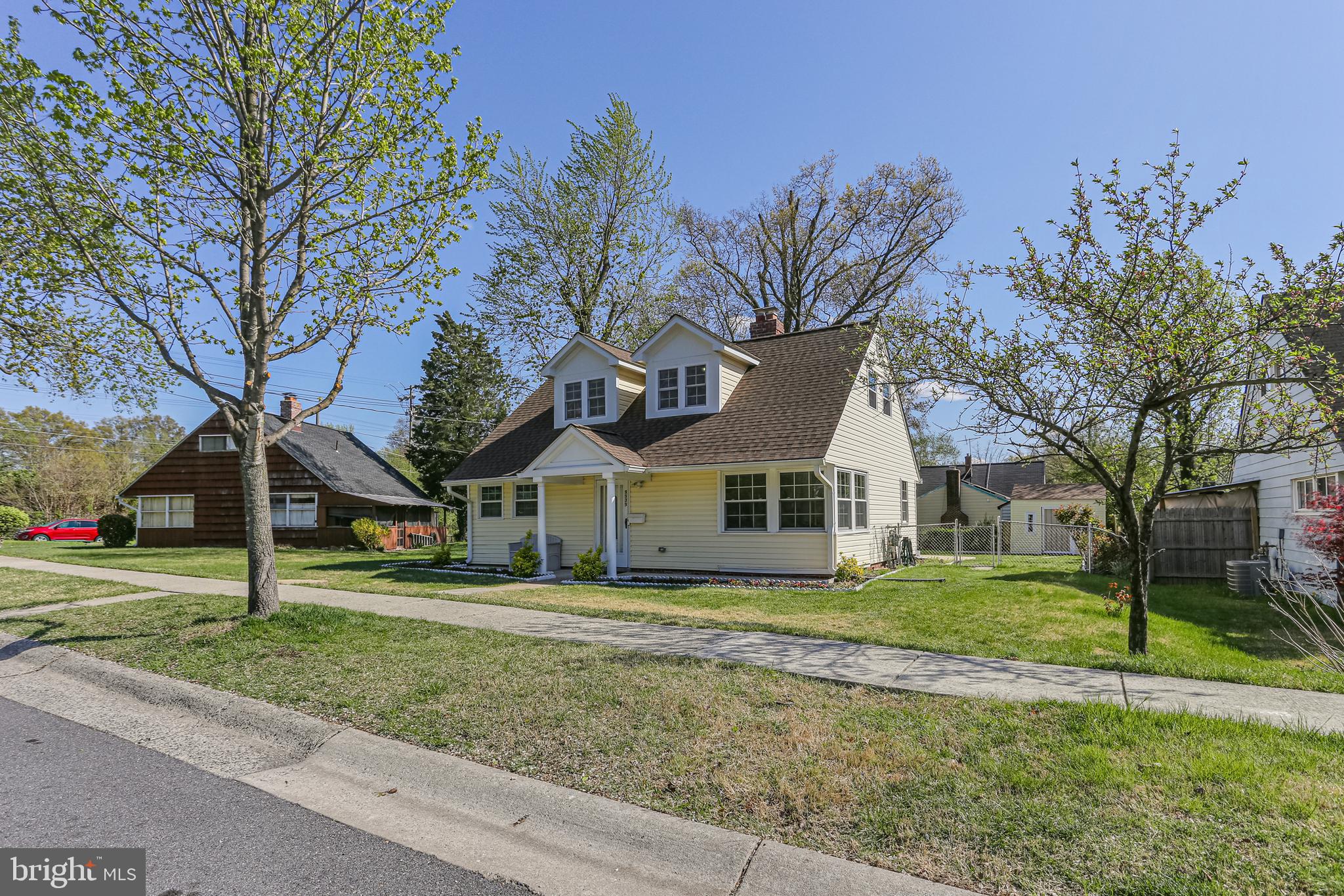 9939 Cottrell Terrace Silver Spring, MD 20903 - Photo 2 of 33 a front view of a house with a yard