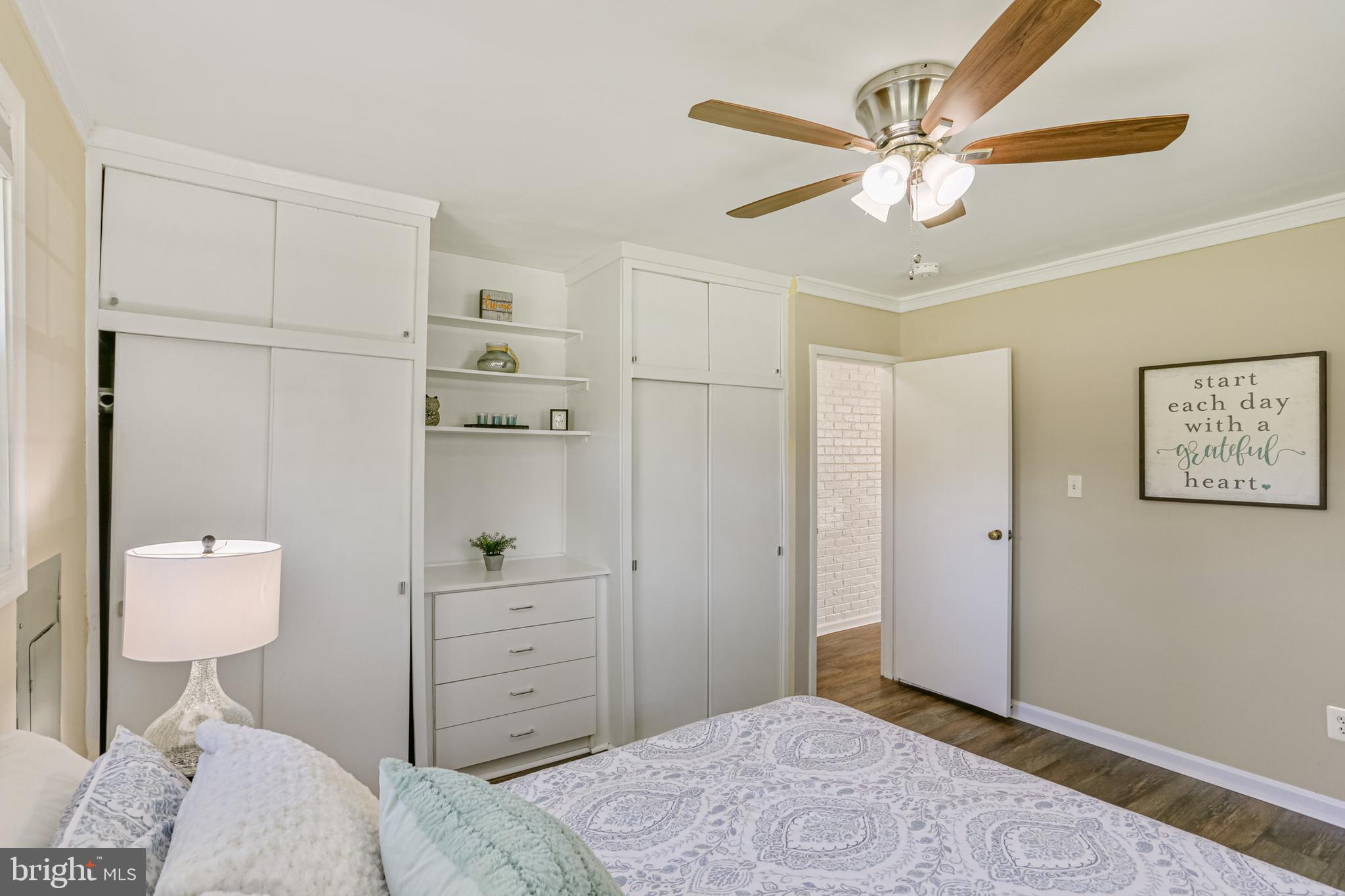 9939 Cottrell Terrace Silver Spring, MD 20903 - Photo 21 of 33 a bedroom with a bed and a chandelier