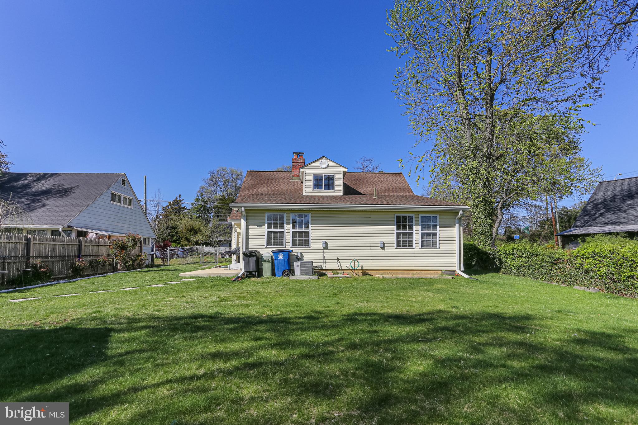 9939 Cottrell Terrace Silver Spring, MD 20903 - Photo 25 of 33 a view of a house with a big yard and large trees