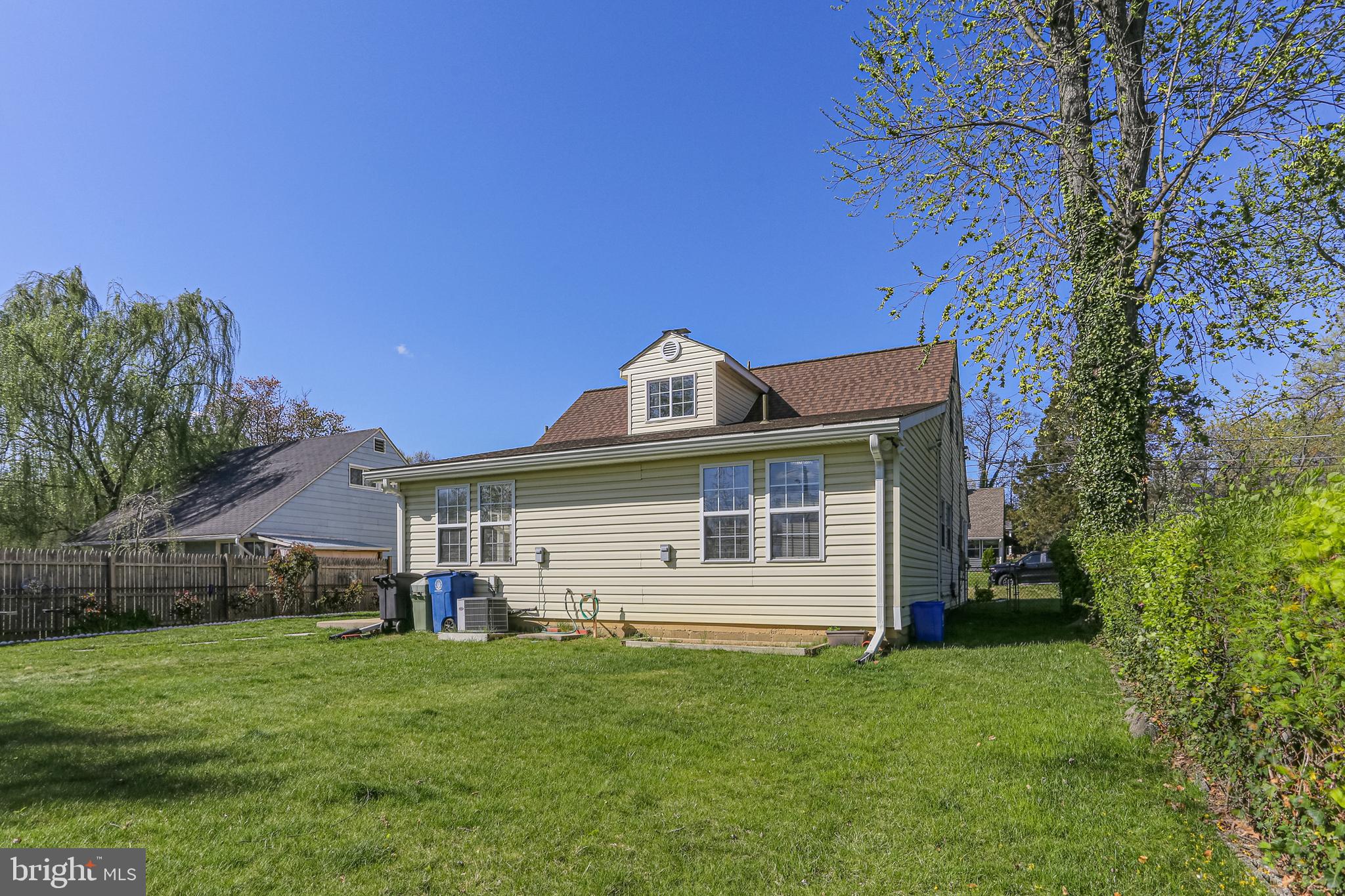 9939 Cottrell Terrace Silver Spring, MD 20903 - Photo 26 of 33 a front view of a house with a garden