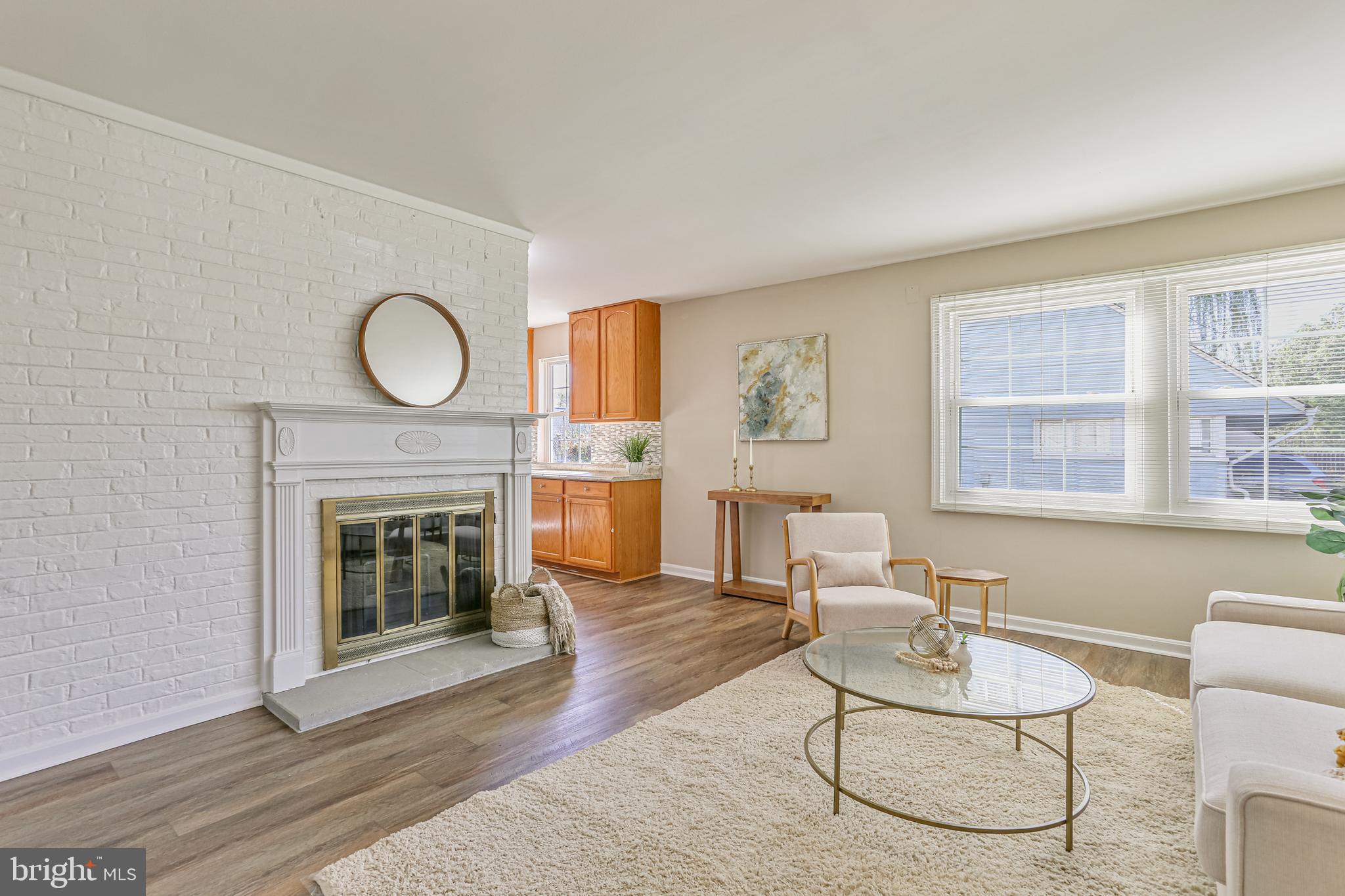 9939 Cottrell Terrace Silver Spring, MD 20903 - Photo 4 of 33 a living room with furniture a window and a fireplace