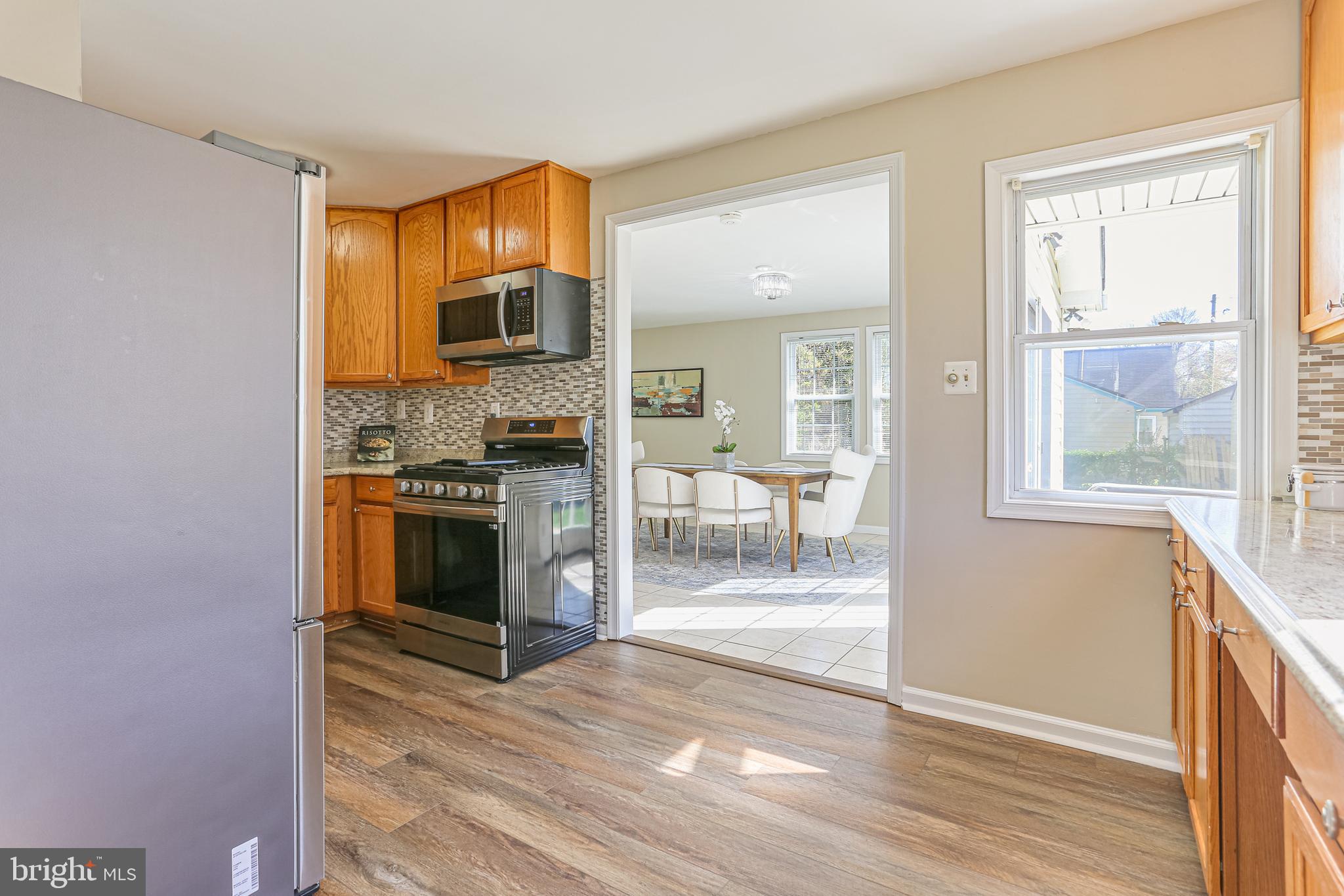 9939 Cottrell Terrace Silver Spring, MD 20903 - Photo 8 of 33 a kitchen with stainless steel appliances granite countertop a stove top oven a sink and a refrigerator