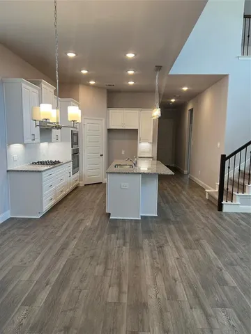 a large kitchen with a table and chairs