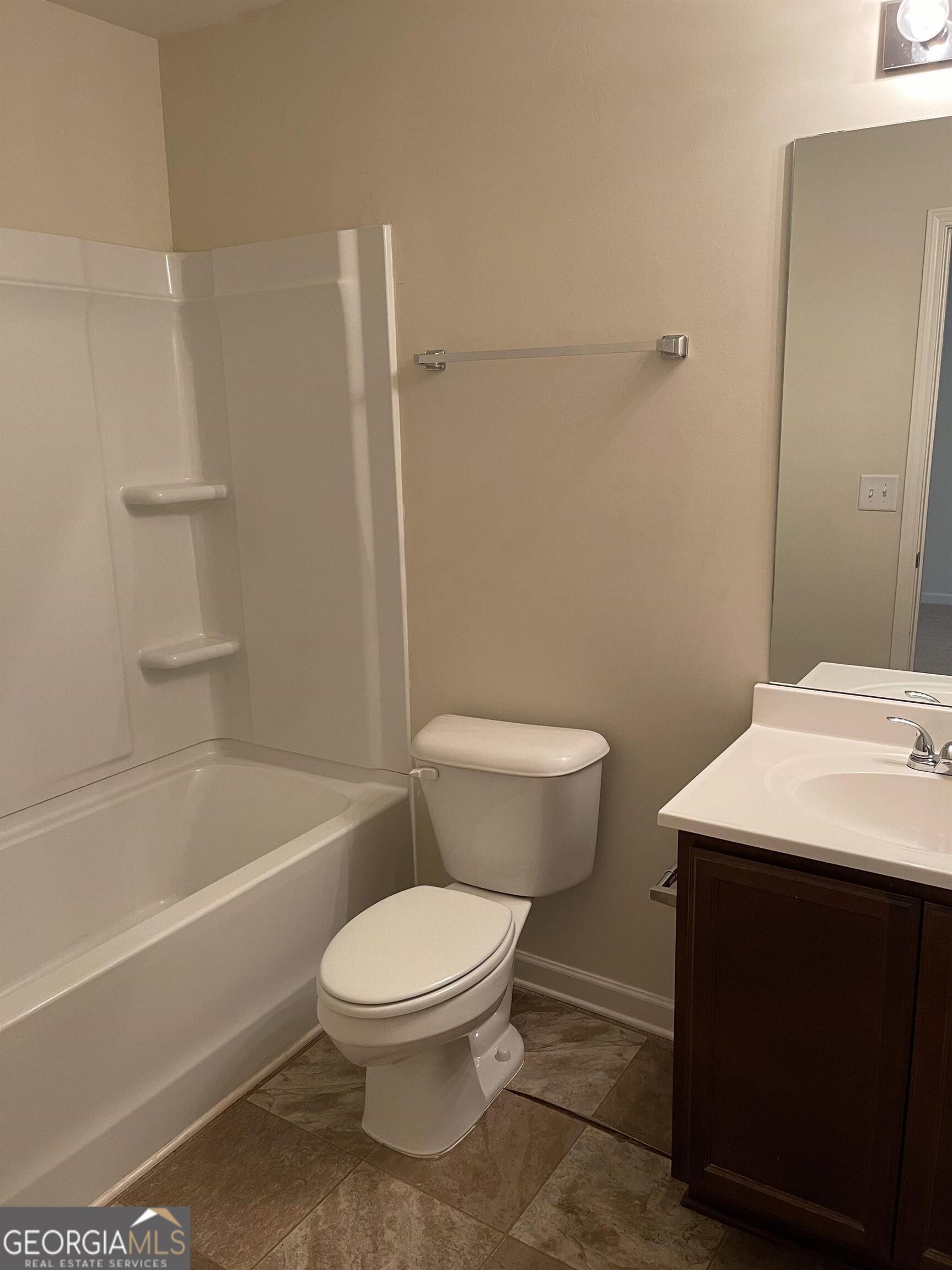 408 Erin Court Villa Rica, GA 30180 - Photo 6 of 16 a bathroom with a toilet a sink and bathtub