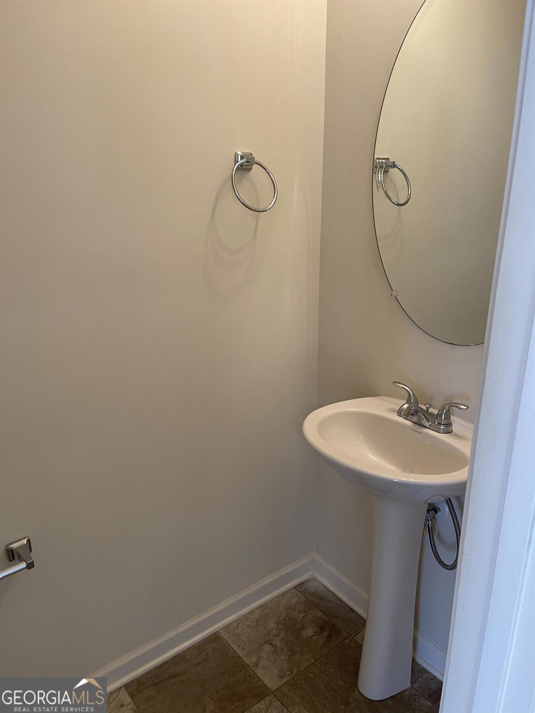 408 Erin Court Villa Rica, GA 30180 - Photo 7 of 16 a bathroom with a sink toilet and mirror