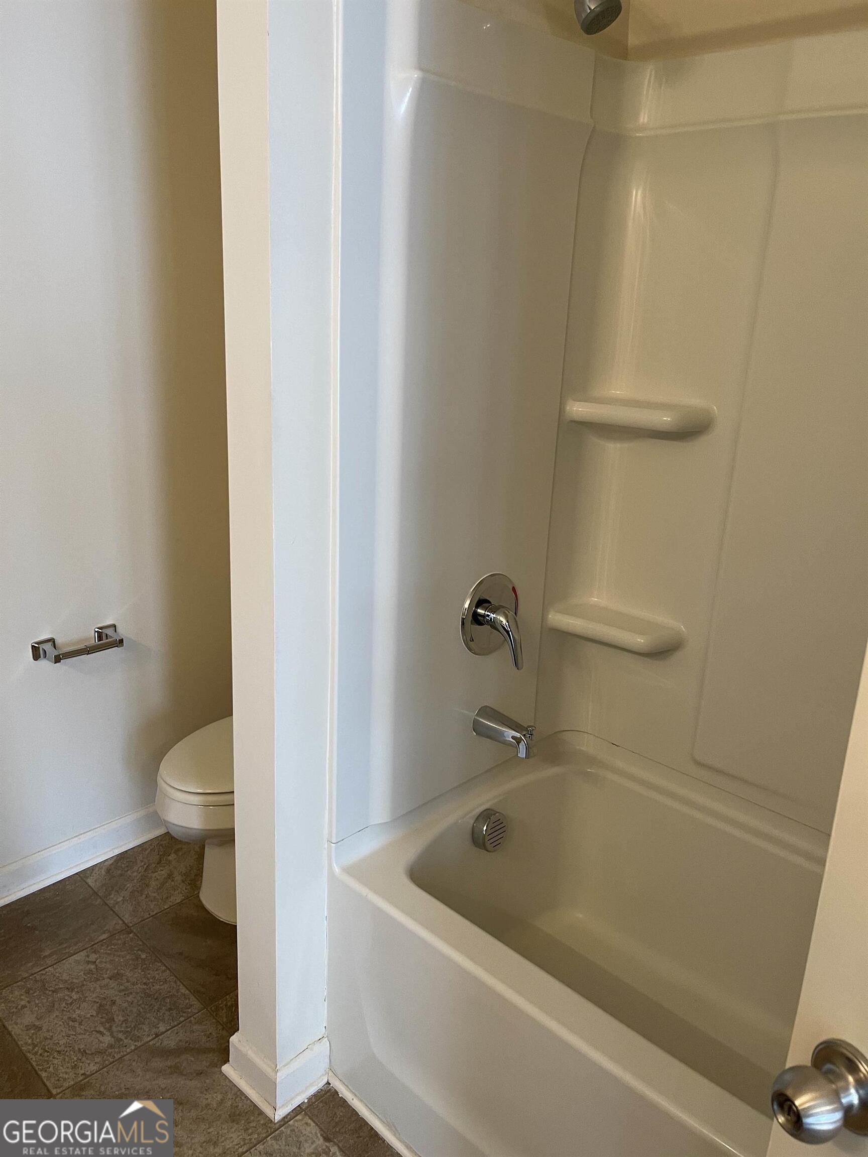 408 Erin Court Villa Rica, GA 30180 - Photo 8 of 16 a bath tub sitting next to a white toilet