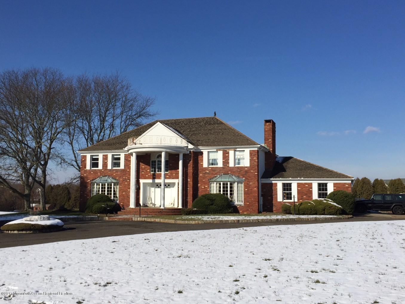 176 Stone Hill Road Colts Neck, NJ 07722 - Photo 1 of 26 a front view of a house with a yard