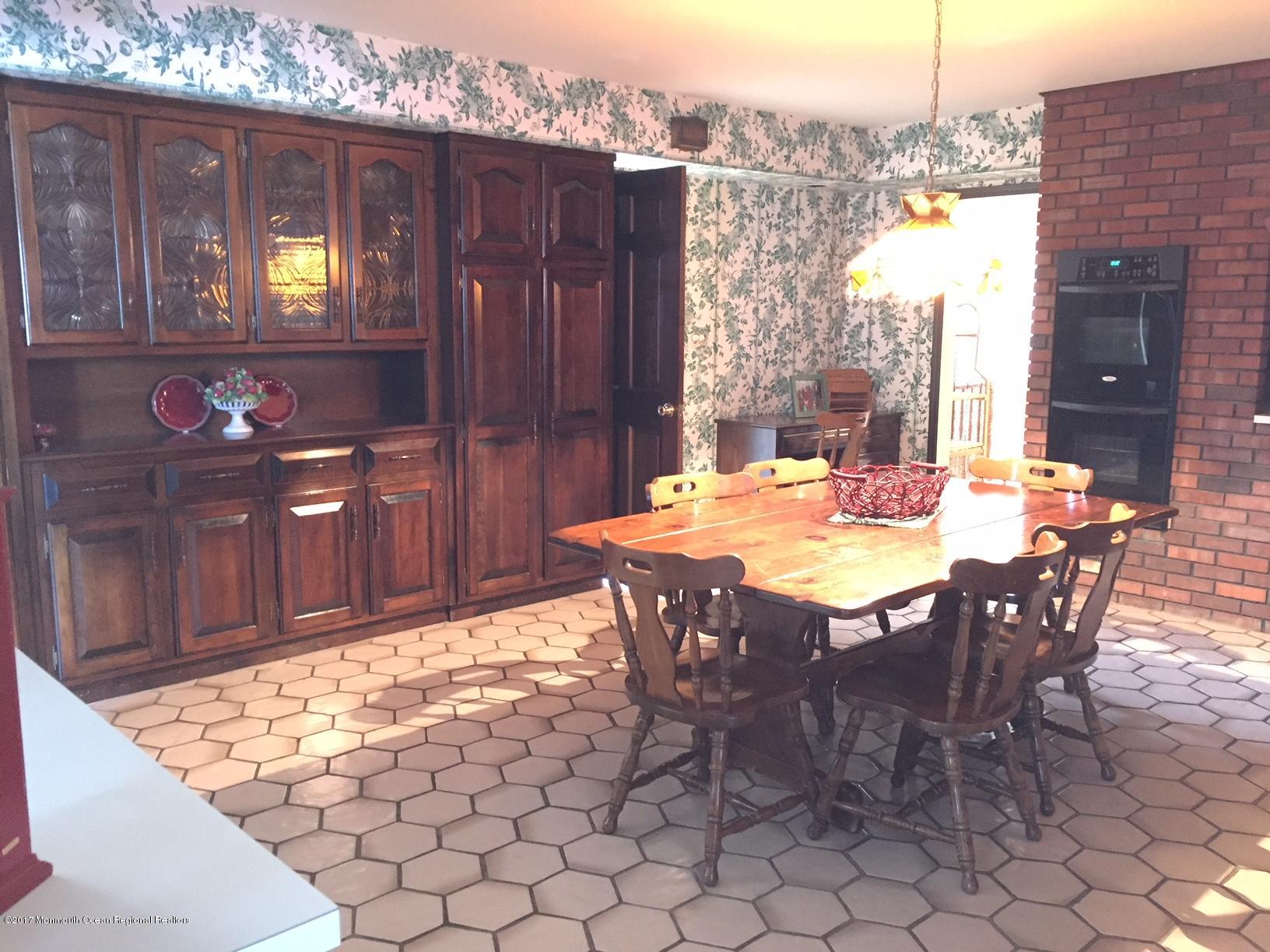 176 Stone Hill Road Colts Neck, NJ 07722 - Photo 11 of 26 a view of a dining table and chairs in a room