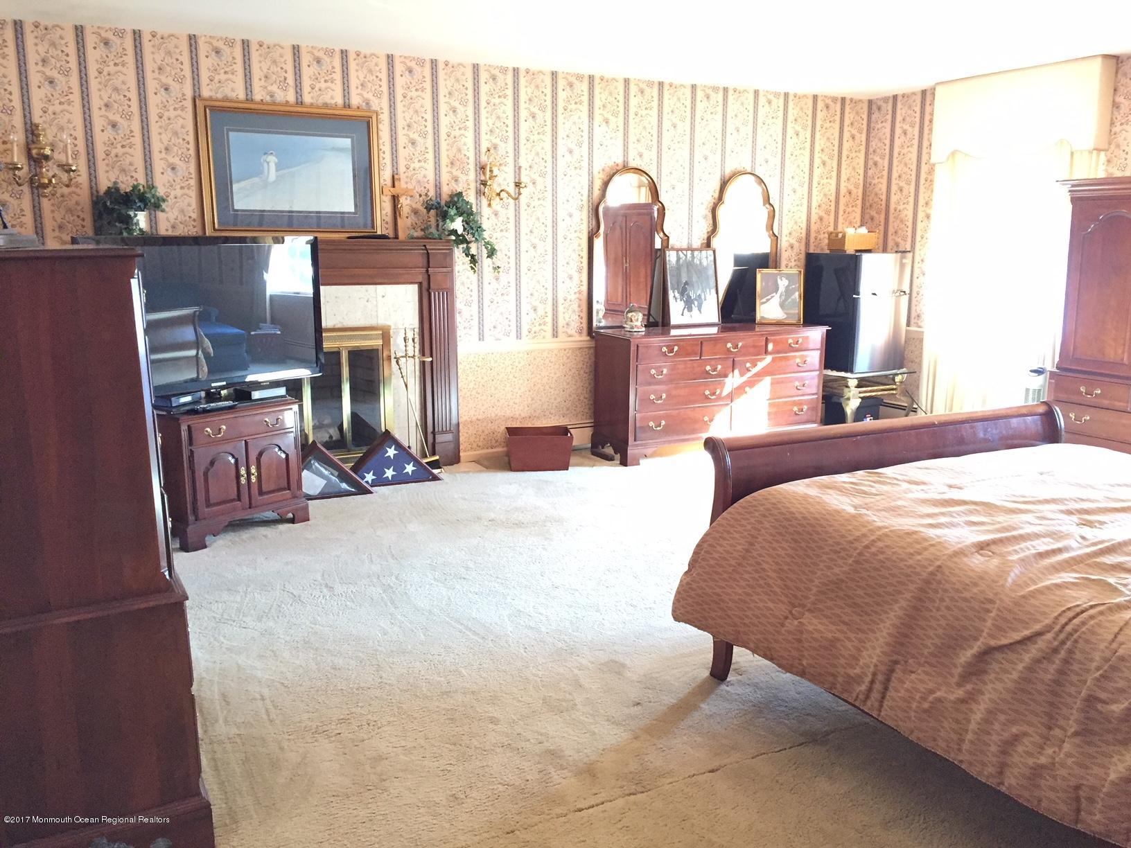 176 Stone Hill Road Colts Neck, NJ 07722 - Photo 19 of 26 a bed room with a bed and dresser with windows