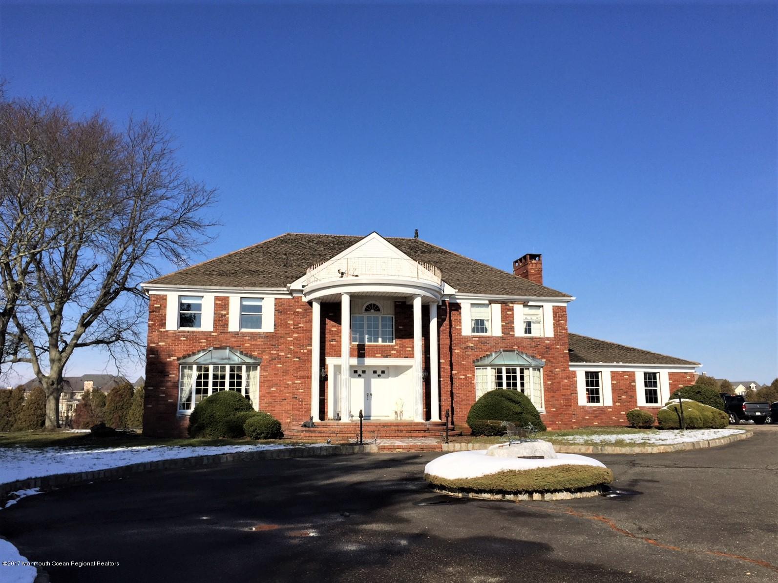 176 Stone Hill Road Colts Neck, NJ 07722 - Photo 2 of 26 a front view of a house with a yard