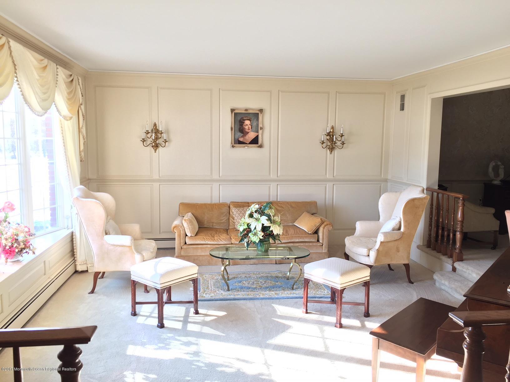 176 Stone Hill Road Colts Neck, NJ 07722 - Photo 4 of 26 a living room with furniture a flat screen tv and a window