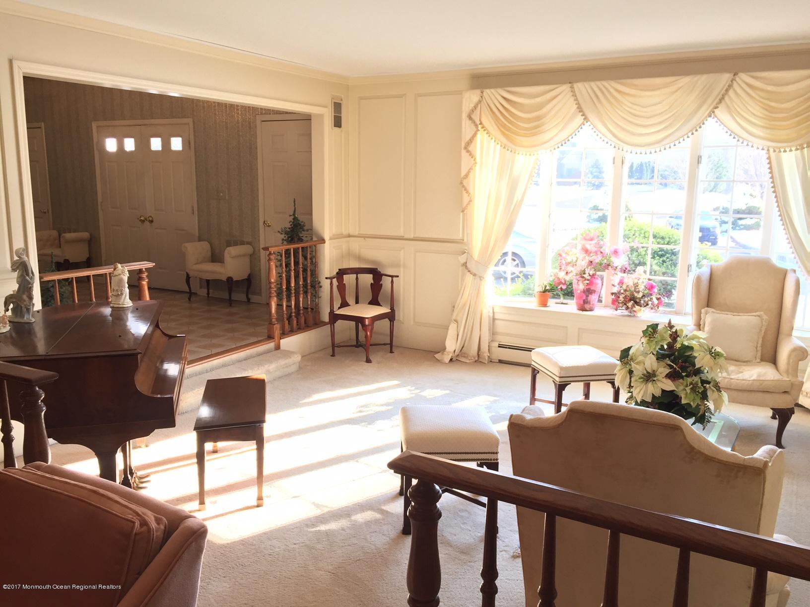 176 Stone Hill Road Colts Neck, NJ 07722 - Photo 5 of 26 a living room with furniture and a large window