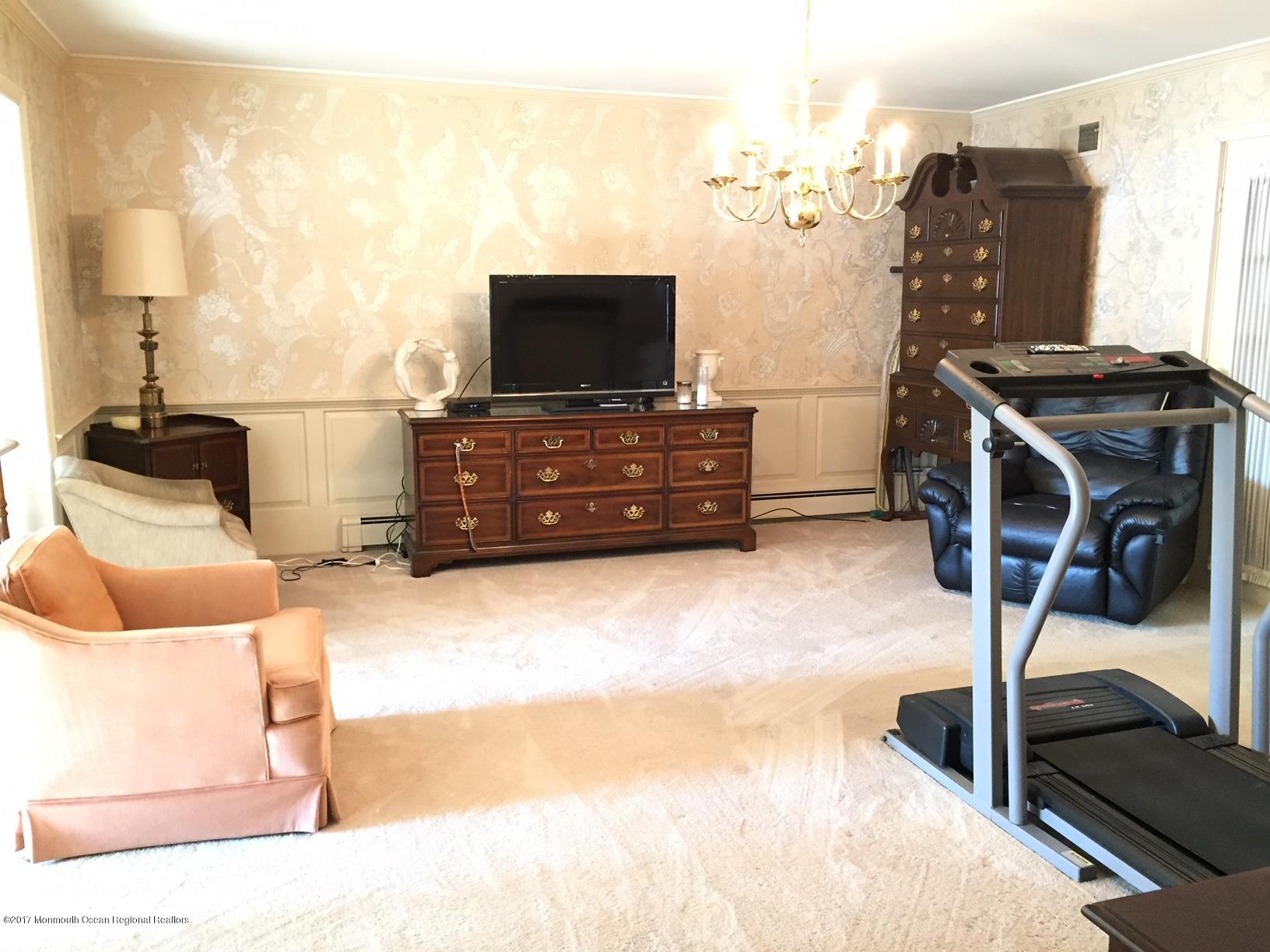 176 Stone Hill Road Colts Neck, NJ 07722 - Photo 6 of 26 a bedroom with furniture and a flat screen tv