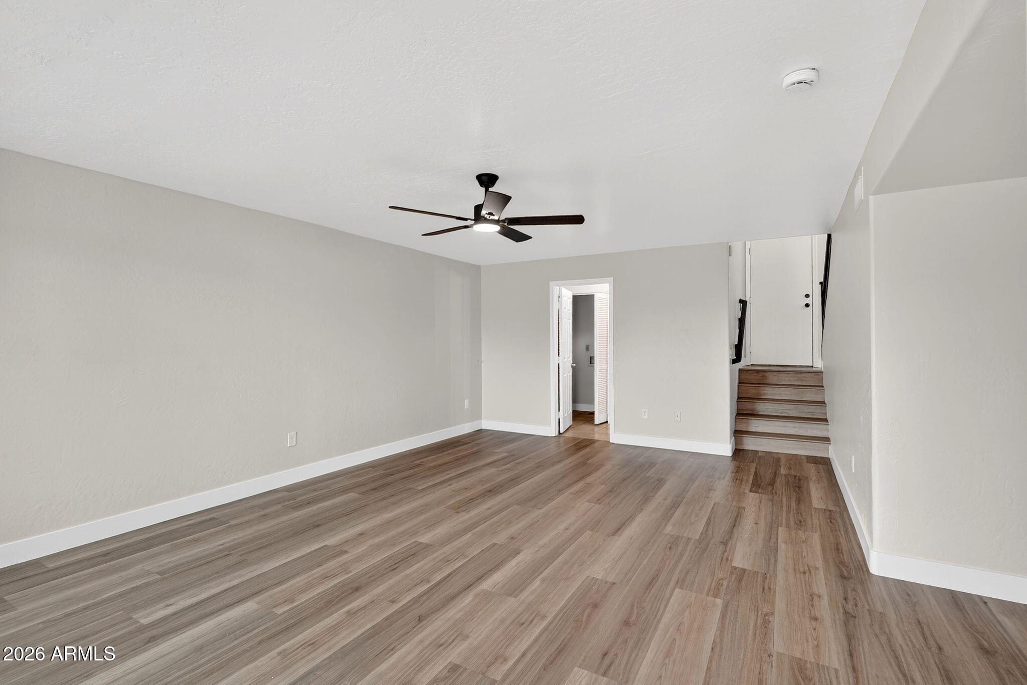 1417 East Mineral Road Gilbert, AZ 85234 - Photo 41 of 59 a view of an empty room with wooden floor and a window