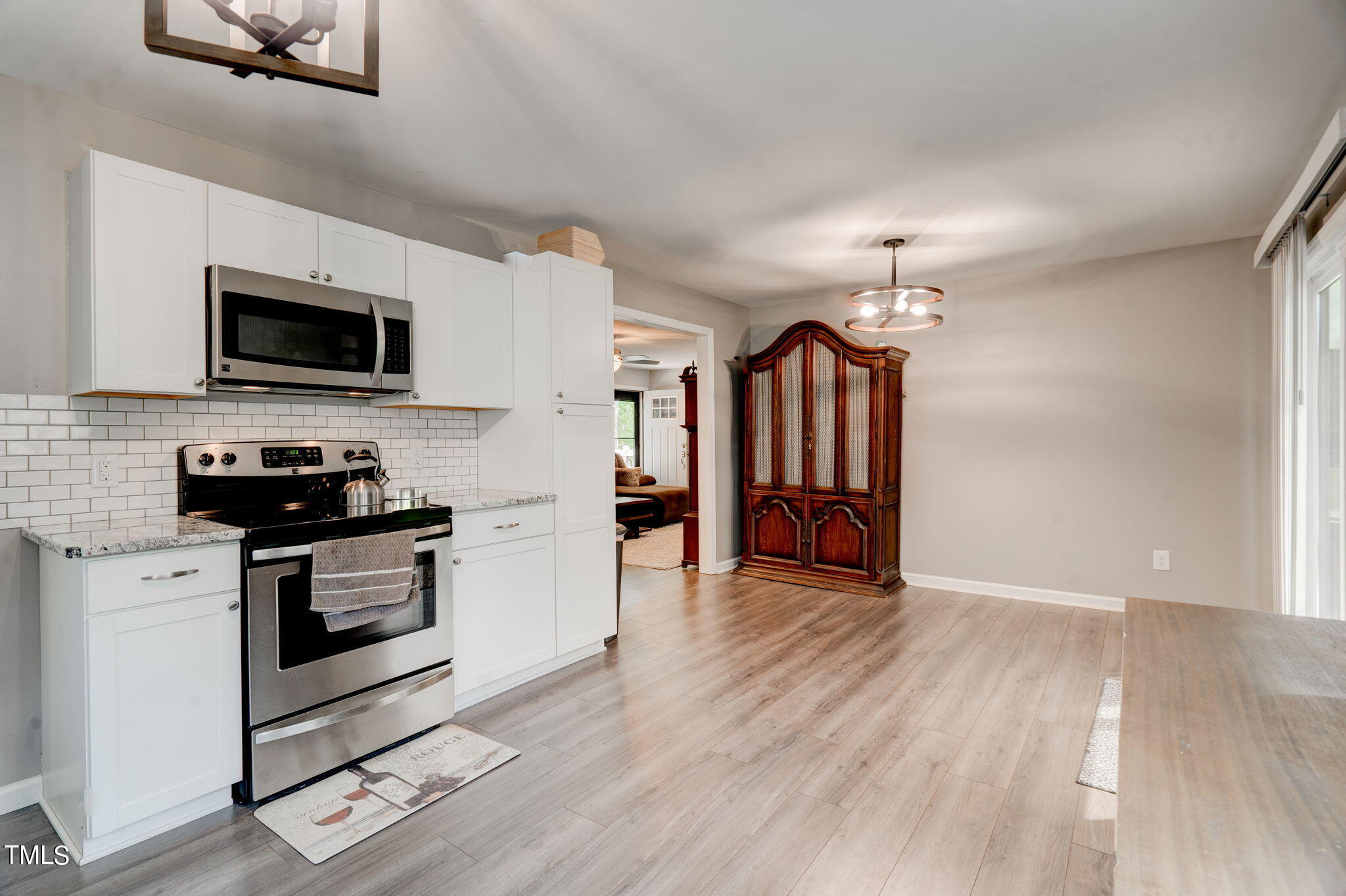 3408 High Gate Road Raleigh, NC 27603 - Photo 19 of 49 a kitchen with wooden floors and stainless steel appliances