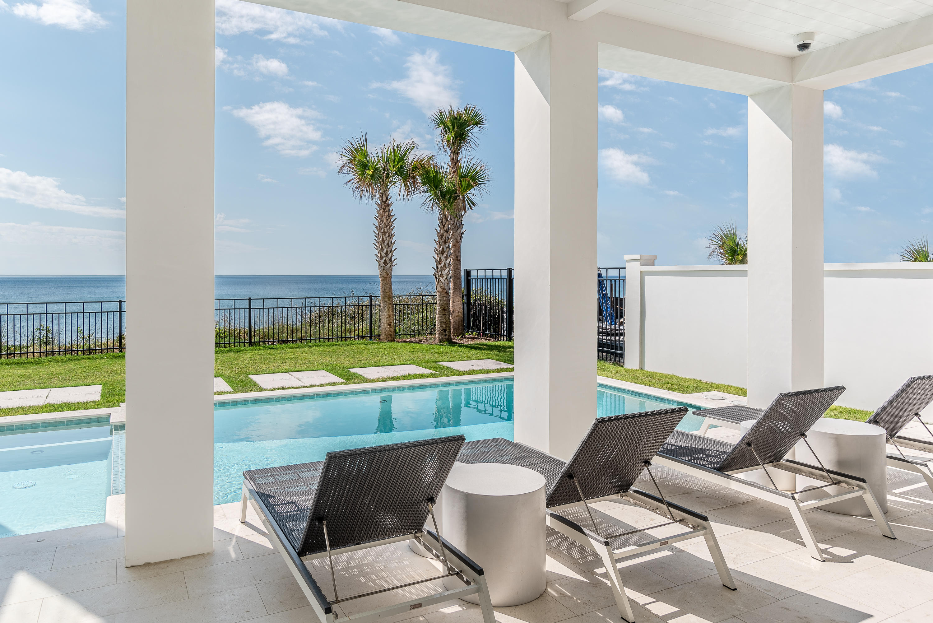 3010 East County Highway 30A Santa Rosa Beach, FL 32459 - Photo 19 of 54 a view of a dining room with furniture and a swimming pool