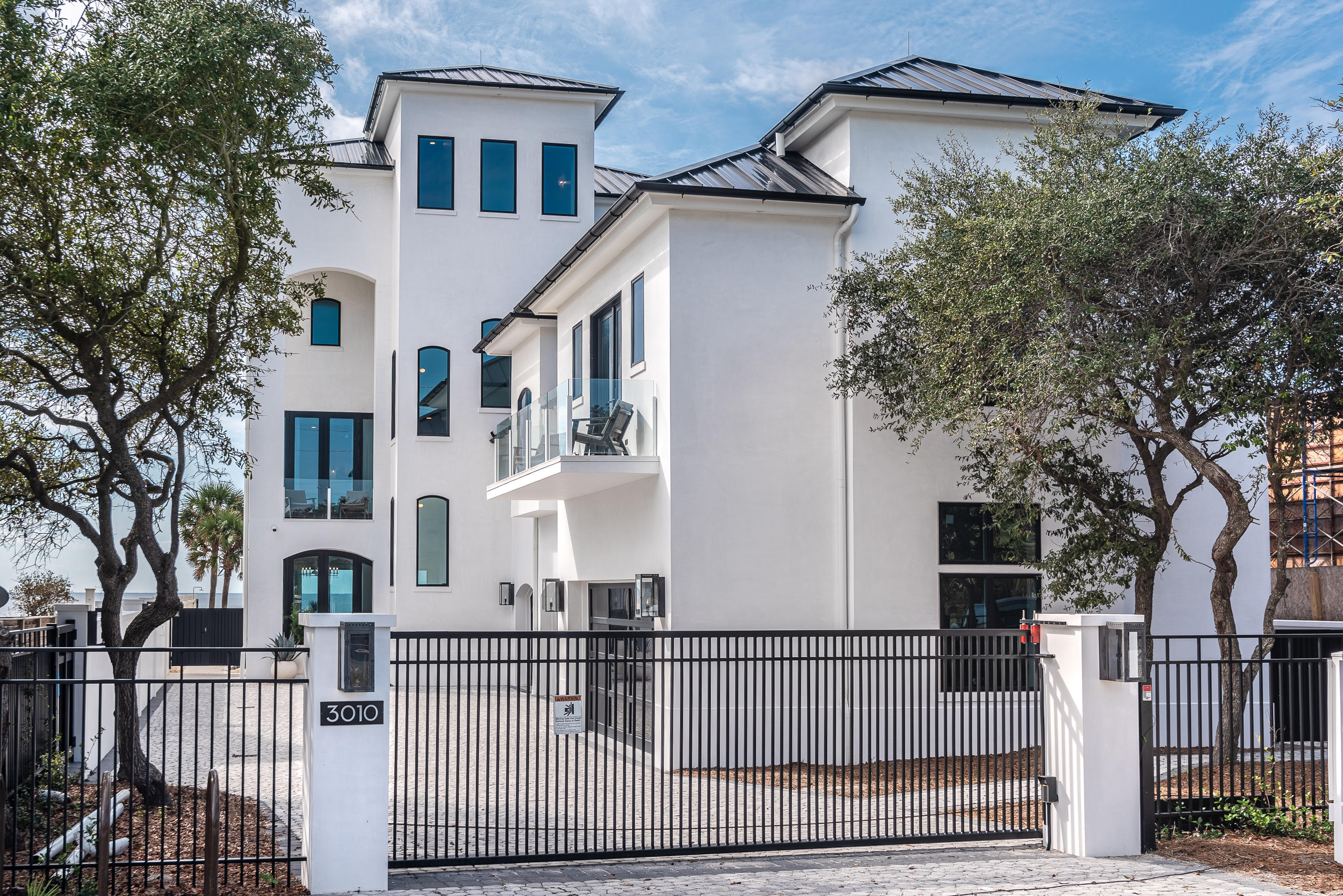 3010 East County Highway 30A Santa Rosa Beach, FL 32459 - Photo 51 of 54 a view of a white house with iron fence