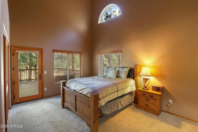 a spacious bedroom with a bed and a window