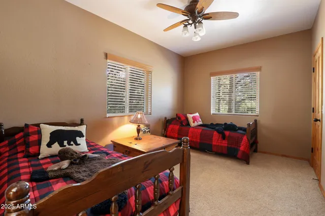 a bedroom with two beds and a chandelier