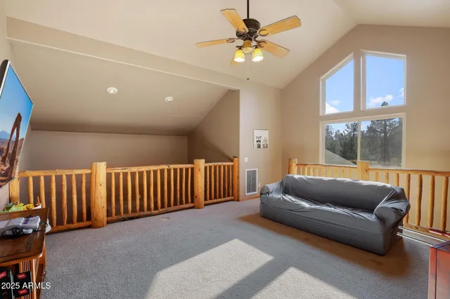 a living room with furniture and a ceiling fan