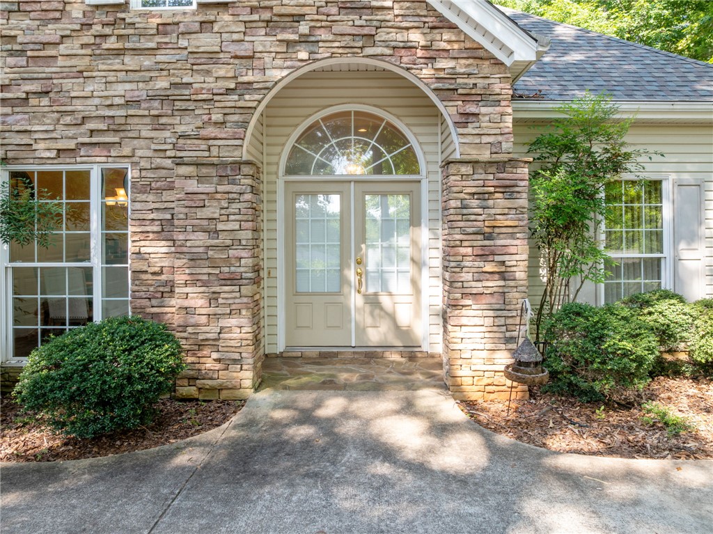 108 Winterbrook Circle Seneca, SC 29678 - Photo 6 of 40 A graceful arched entry framed by stacked stone and inviting glass-paned doors.