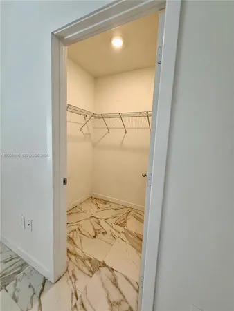 a bathroom with a shower and a glass door