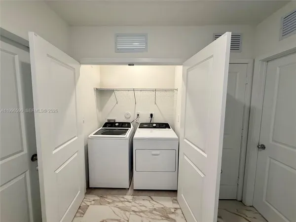 a utility room with dryer and washer
