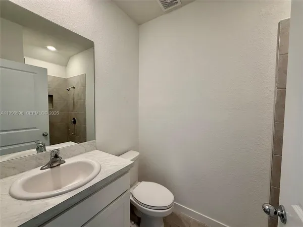a bathroom with a sink toilet