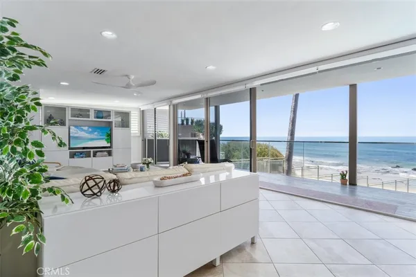 a large white room with a large window and furniture