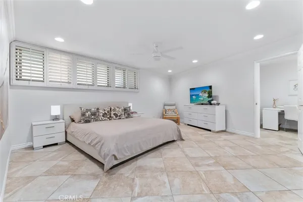 a spacious bedroom with a bed and a cabinets