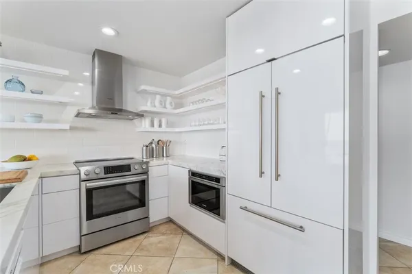 a kitchen with stainless steel appliances and white cabinets