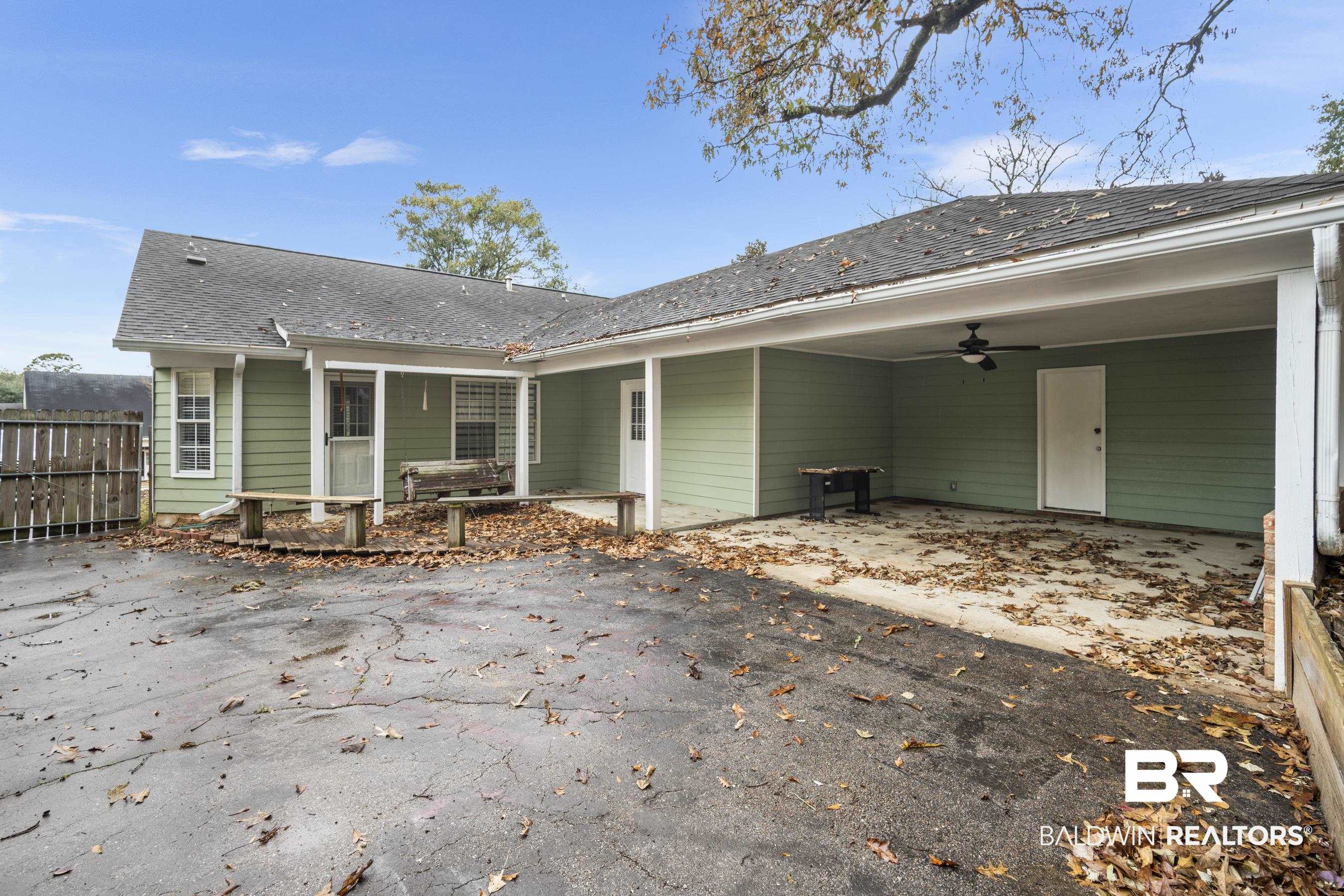 3101 Autumn Ridge Drive West Mobile, AL 36695 - Photo 28 of 36 Rear view of house with a patio, roof with shingles, a ceiling fan, and asphalt driveway