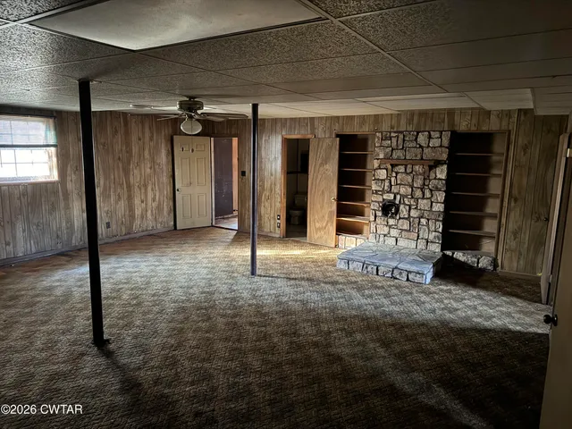 a view of an empty room with a fireplace